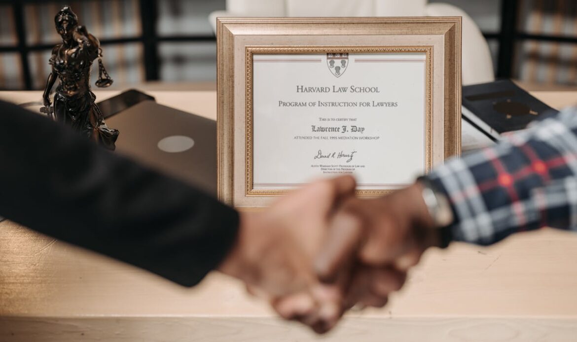 Harvard Law School degree with handshake representing achievement and professional agreement.