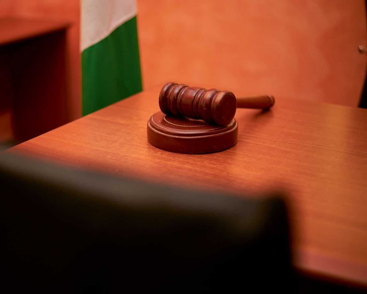 About US A close-up of a gavel on a courtroom desk representing law and justice.