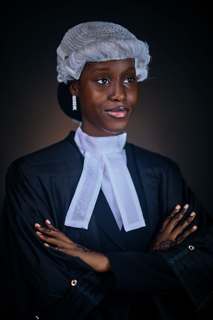 Services Young female lawyer in traditional attire poses confidently, symbolizing justice and professionalism.